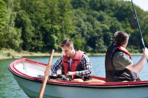 Two men fishing from a boat in South Carolina, one with a fishing license.