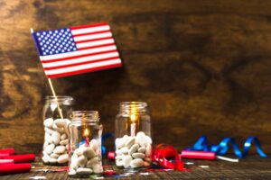 American flag and festive jars with candles, hinting at new South Carolina red drum regulations 2026.